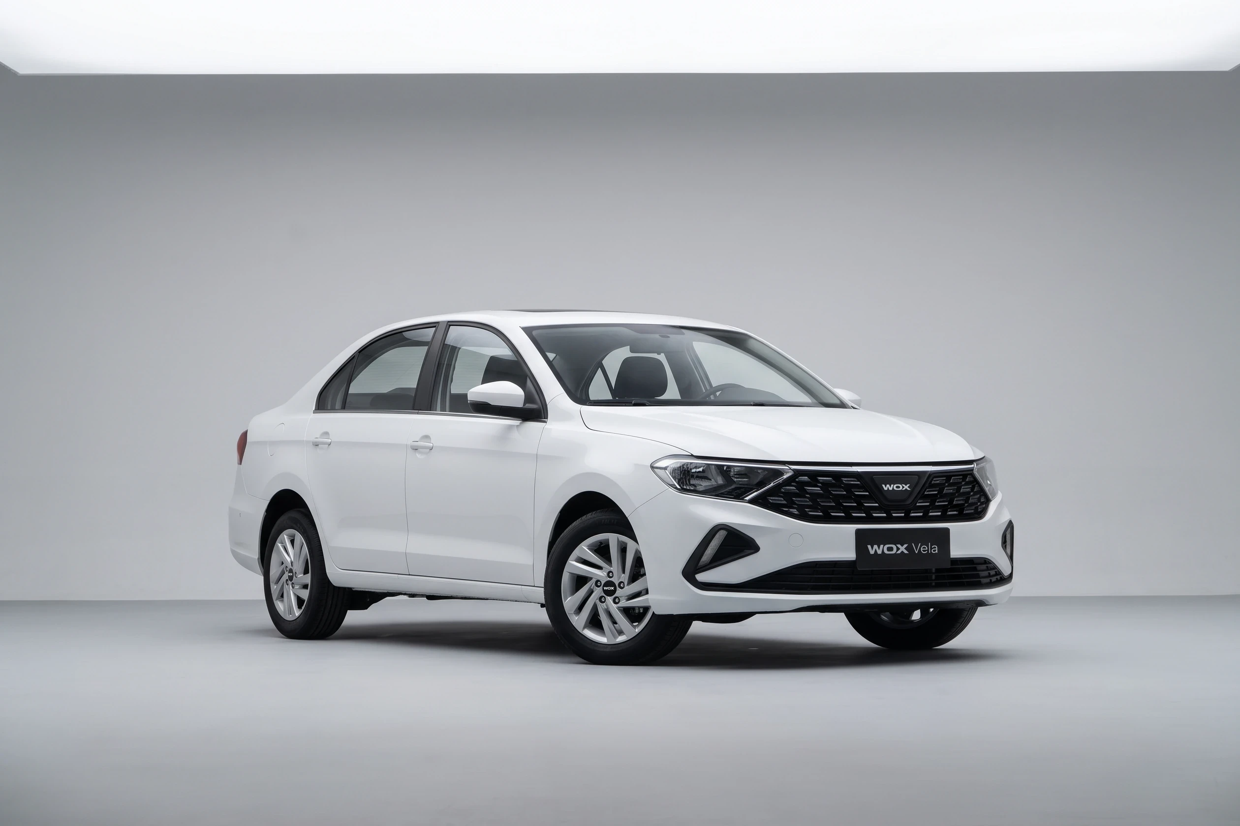 White WOX Vela sedan, front studio view