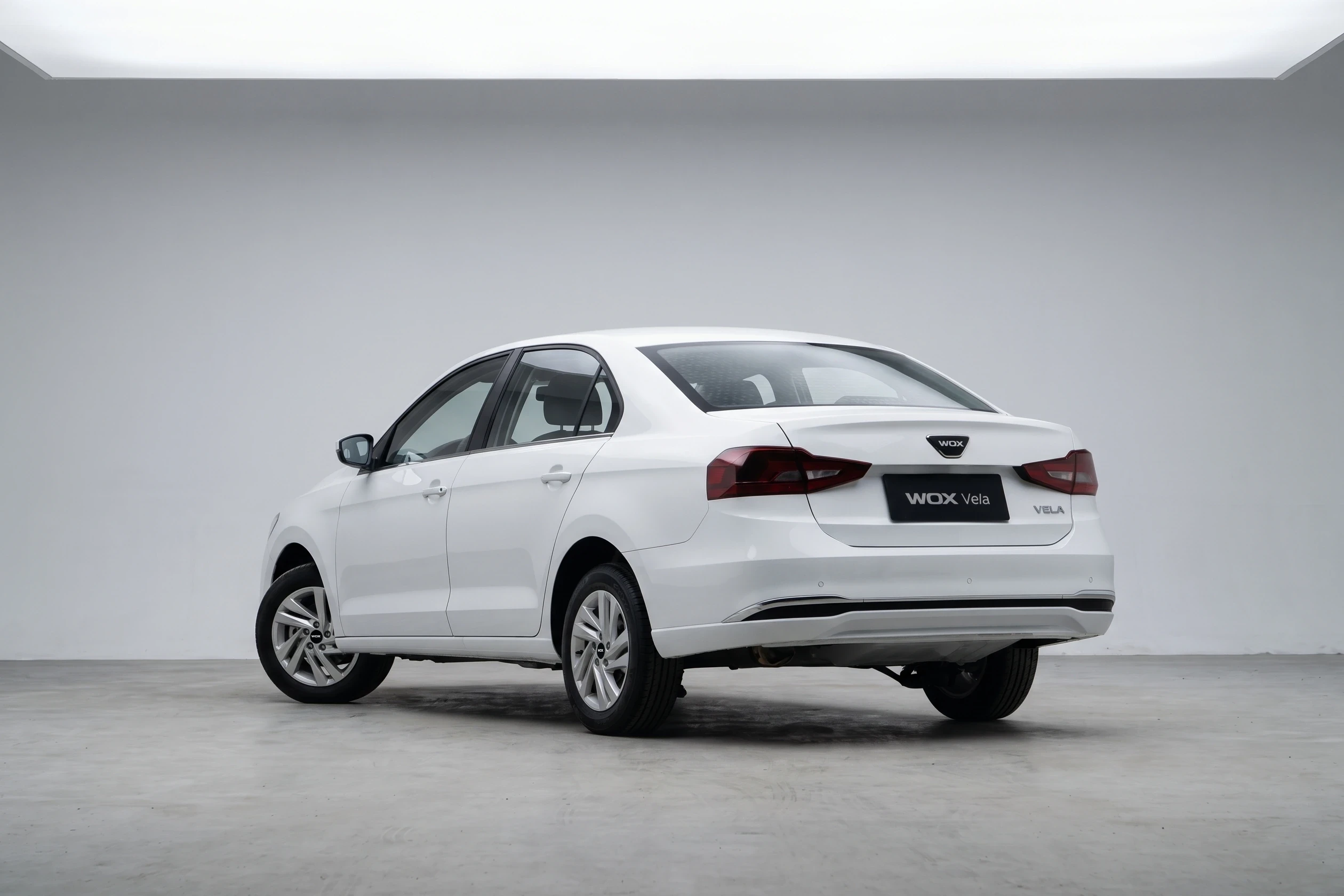 White WOX Vela sedan, rear studio view